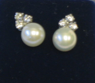 A pair of lady's pearl and diamond earrings (approx 0.42ct)