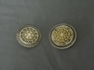 2 mother of pearl and "silver" mounted circular brooches