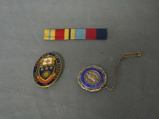 A Royal College of nursing enamel brooch, a Central Nursing Association of England and Wales silver and enamel brooch and 2 medal ribbons