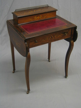 A Victorian inlaid rosewood drop flap writing table the top with fitted stationery box (slight smile) having an inset tooled leather writing surface, the base fitted a drawer and raised on cabriole supports (crack to the right hand side, recently repolished) 23"