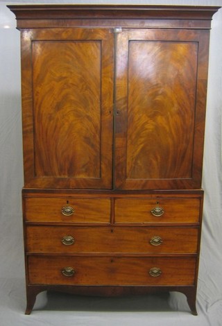 A Georgian mahogany linen press with moulded cornice, the interior fitted 3 drawers enclosed by panelled doors, the base fitted 2 short and 2 long drawers with brass escutcheon and plate drop handles (slight spring to doors and 2 drawers forced at some time) 48"