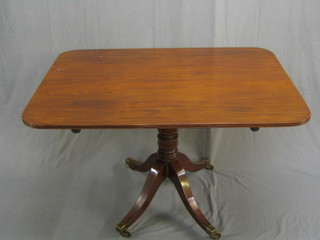 A Georgian rectangular mahogany snap top breakfast table, raised on a gun barrel and tripod column with brass caps and castors, 48" (with associated bolts)