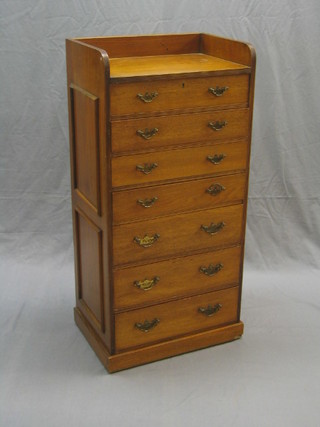 A 19th/20th Century  walnut campaign style chest with three-quarter gallery, fitted 7 drawers with pierced brass plate drop handles, raised on a platform base 22"