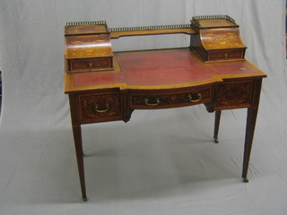 A handsome Edwardian inlaid mahogany Carlton House table with brass gallery and stationery box to the side (gallery loose) with inset tooled leather writing surface, fitted 1 long drawer flanked by 2 short drawers, raised on square tapering supports ending in  brass caps and castors (missing some crossbanding to front, missing 1 brass swan neck drop handle and some water damage to top left hand stationery box) 42"