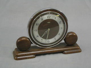 A 1950's Metamec mantel clock with silvered dial and Arabic numerals contained in an oak case