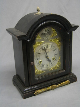 A reproduction 18th Century style striking bracket clock with arch shaped dial having Roman numerals  by Lincoln contained in an ebony and gilt mounted case
