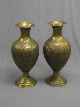 A large and impressive pair of 20th Century Eastern embossed brass vases of baluster form 31"