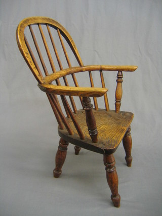 A 20th Century childs elm stick and rail back chair with solid seat (split to seat and old repair to back rail