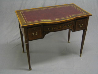 An Edwardian inlaid mahogany writing table with crossbanded top, satinwood stringing and inlaid a tooled leather writing surface, the base fitted 1 long drawer flanked by 2 short drawers, raised on square tapering supports 36"