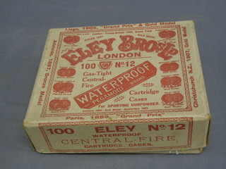 A 1930's Eley Bros. paper cartridge box marked 100 Eley No. 12 Waterproof Central-Fire cartridge cases containing a wooden bung and  a breathing mask