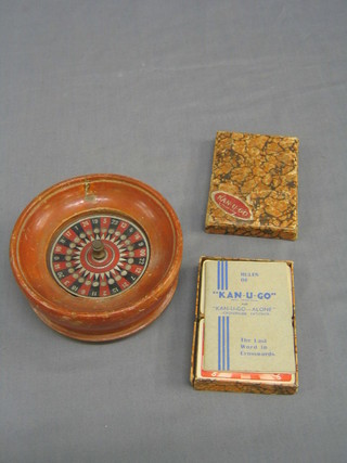 A 1930's German roulette wheel 5 1/2" and a Can-U-Go card game