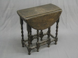 A Victorian oak oval drop flap gateleg tea table, raised on spiral turned supports 25"