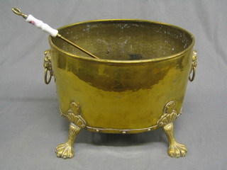 An oval brass coal bucket with brass drop handles, 16" together with a toasting fork