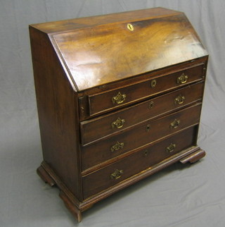 A Georgian mahogany bureau, the fall front revealing a well fitted interior, (fall front with old patch), fitted 4 long graduated drawers and raised on ogee bracket feet 36"