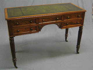 A Victorian mahogany writing table with inset tooled green leather top, fitted 5 short drawers, raised on turned and reeded supports ending in caps and castors (recently restored)
