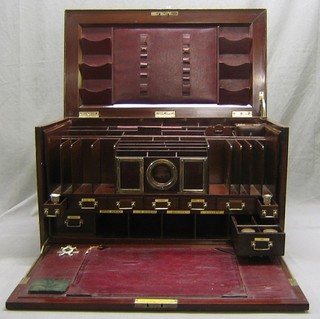 A handsome Anglo-Oriental Edwardian inlaid mahogany stationery box, the interior fitted numerous pigeon holes and having silver mounts to the front with 2 fitted photograph frames, pocket watch receptical, all silver mounted, drawer fitted 2 silver mounted candle sconces, ink drawer fitted 2 cut glass and silver mounted inkwells, leather telegram blotter, all contained with an inlaid mahogany carrying case with twin handles 30"