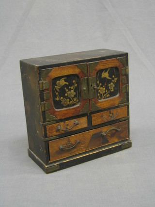 A miniature Oriental cabinet, the upper section 4 drawers enclosed by panelled doors, the base fitted 2 short and 1 long drawer, 8"