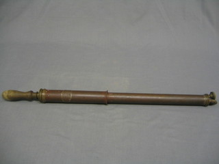 A copper garden syringe