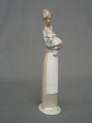 A Lladro figure of a standing girl with lamb, base marked Lladro (ref L505) 11"