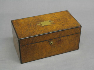 A rectangular Victorian figured walnut tea caddy with brass shell to the top and Bramah lock, the interior fitted 2 coromandel tea caddies and with illegible brass plate to the centre, 12"