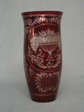 A red Bohemian etched glass vase decorated a vase of flowers 10"