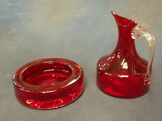 A Whitefriars red glass ashtray  5 1/2" and a Whitefriars jug with clear glass handle 6"