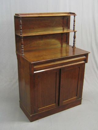 A 19th Century mahogany chiffonier with raised back and crossbanded decoration, fitted a drawer and a cupboard enclosed by panelled doors, raised on a platform base 35"