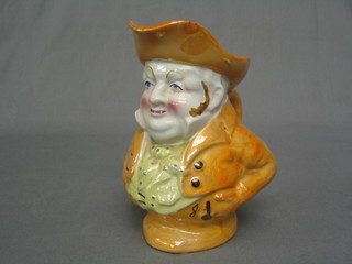 A 19th Century orange glazed Toby jug in the form of Toby Philpot