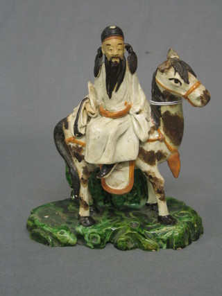 A 19th Century Oriental pottery spill vase in the form of a figure riding a horse 6" (horses ear f)