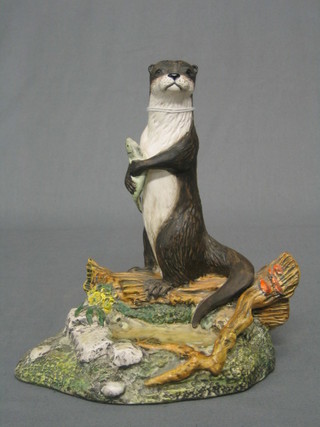 A Royal Doulton biscuit pottery figure of a standing otter with fish, 7"