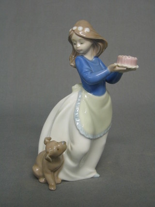 A Nao figure of a standing girl with cake and seated dog, the base marked Nao 7"