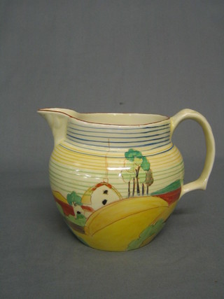 An oval Clarice Cliff jug decorated a cottage with striped decoration, the base marked Clarice Cliff Wilkinson Ltd England, (handle restored and chip to rim) 6"
