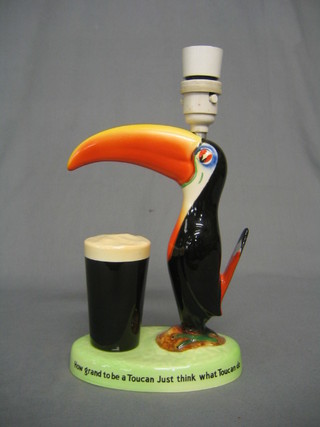 A Carlton Guinness advertising table lamp decorated a Toucan and pint of Guinness, the base marked produced in Great Britain for Arthur Guinness & Sons & Co (Park Royal Ltd) by Carltonware Ltd GA/1278, bearing the inscription "How Grand to be a Toucan, Just Think What Toucan Do" (tail f and r) 