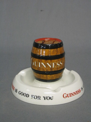 A Mintons Guinness advertising ashtray/match box stand in the form of a barrel of Guinness, the base marked Guinness is Good for You, the underside marked G/A/20?, Produced in Great Britain by Mintons Ltd Stoke on Trent, RD no. 778941