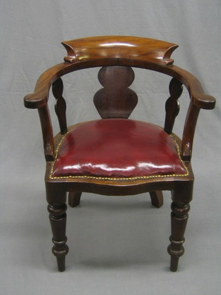 A 19th Century mahogany captain's/smoker's bow chair, the seat upholstered in red rexine, raised on turned supports (with iron panel to the base)