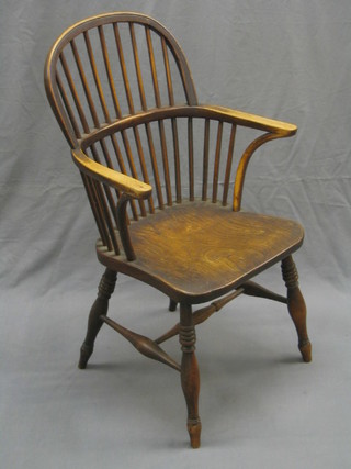 A 19th/20th Century elm comb back carver chair with solid seat