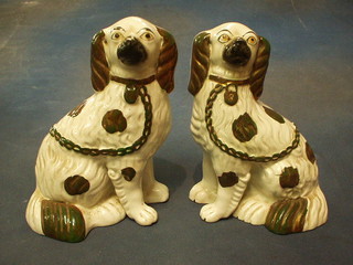 A pair of 19th Century Staffordshire figures of seated Spaniels (1 heavily cracked to the base) 9"