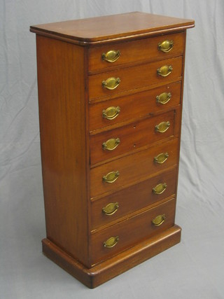 An Edwardian Wellington style chest of 7 long drawers with brass plate drop handles, raised on a  platform base 24"