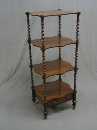 A Victorian rosewood 4 tier what-not of serpentine outline, raised on spiral columns the base fitted a drawer with tore handles and bun feet 19" (recently repolished)