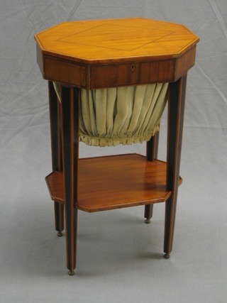 A 19th Century lozenge shaped satinwood work table inlaid ebony stringing, with deep basket raised on tapering supports united by an undertier 19" (some veneer loss)