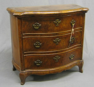 A 19th Century miniature Dutch chest of serpentine outline with crossbanded top, fitted 4 long drawers, raised on French cabriole supports 25"