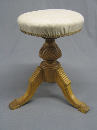 A Victorian bleached oak revolving adjustable piano stool (mechanism requires attention)