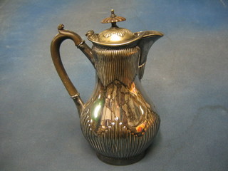 An oval silver plated hotwater jug with demi-reeded decoration