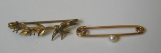 A gold bar brooch set a seed pearl together with a gilt metal bar brooch