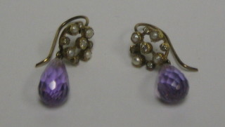 A pair of amethyst tear drop earrings surmounted by pierced gilt circles set 4 demi-pearls and 5 diamonds