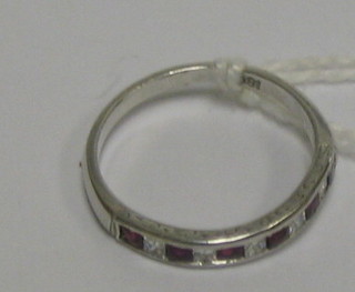 A lady's 18ct white gold half eternity ring set 6 rubies interspaced by 5 diamonds (approx 0.56ct)
