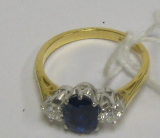 A lady's handsome 18ct gold dress ring set an oval cut sapphire supported by 2 diamonds (approx 0.40/1.80ct)