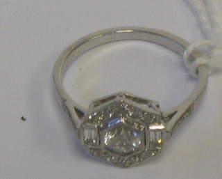 A lady's Art Deco style 18ct gold dress ring set a circular cut diamond supported by 2 baguette cut diamonds and numerous other diamonds (approx 0.85ct)
