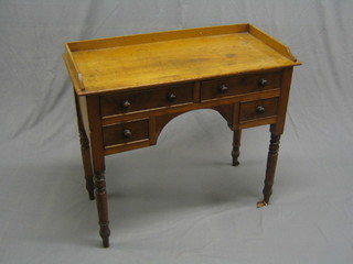 A 19th Century mahogany dressing table with three-quarter gallery fitted 2 long drawers above 2 short drawers raised on turned supports 35"