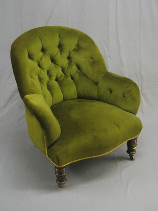 A Victorian mahogany and iron framed armchair upholstered in green buttoned back material, raised on turned supports